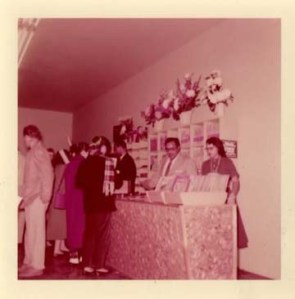 Marilyn Kelley, fifteen, helping customers with Henry Bass and Harold Kelley at the Main Street shop, 1955.