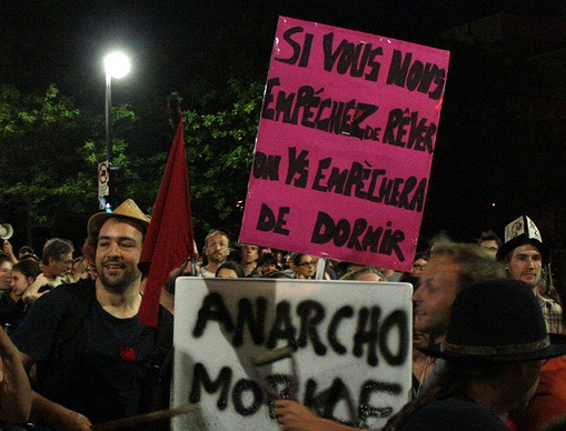 Protestors with signs that say ""If you keep us from dreaming, we'll keep you from sleeping," Image from Flickr user ScottMontreal