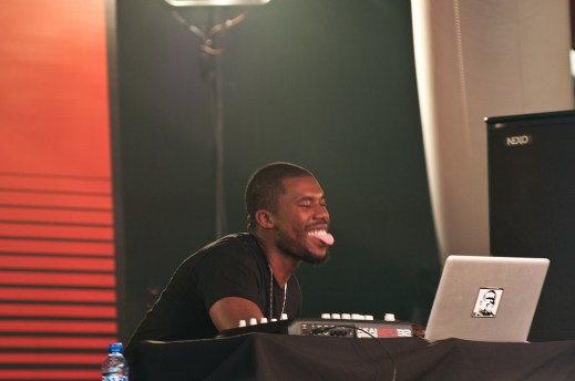 Flying Lotus playing live, enjoying himself with his tongue out @ SonarDome, Sonar 2012, Image by Flickr user Boolker