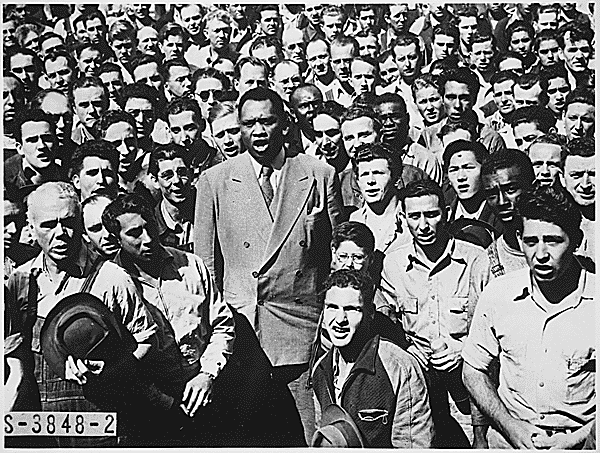 Photograph of Paul Robeson Leading Moore Shipyard Workers in Singing the "Star Spangled Banner," Oakland, CA, September 1942, Image courtesy of National Archives and Records Administration Still Picture Branch Record Group 208 National Archives Identifier: 535874