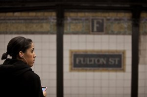 A woman waits at the Fulton Street subway stop in New York City on February 20, 2010.