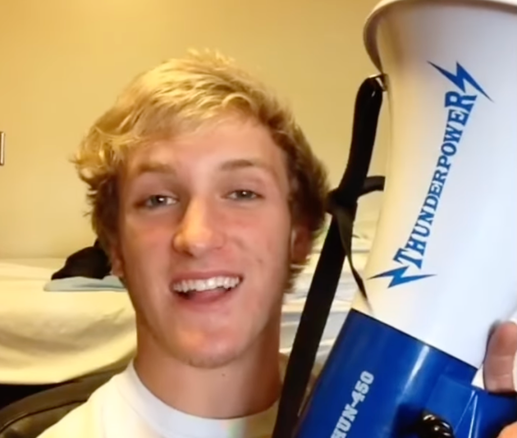Blonde white male teenager holding a blue and white bullhorn
